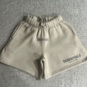 Kids Essentials fear of god sweat shorts.
